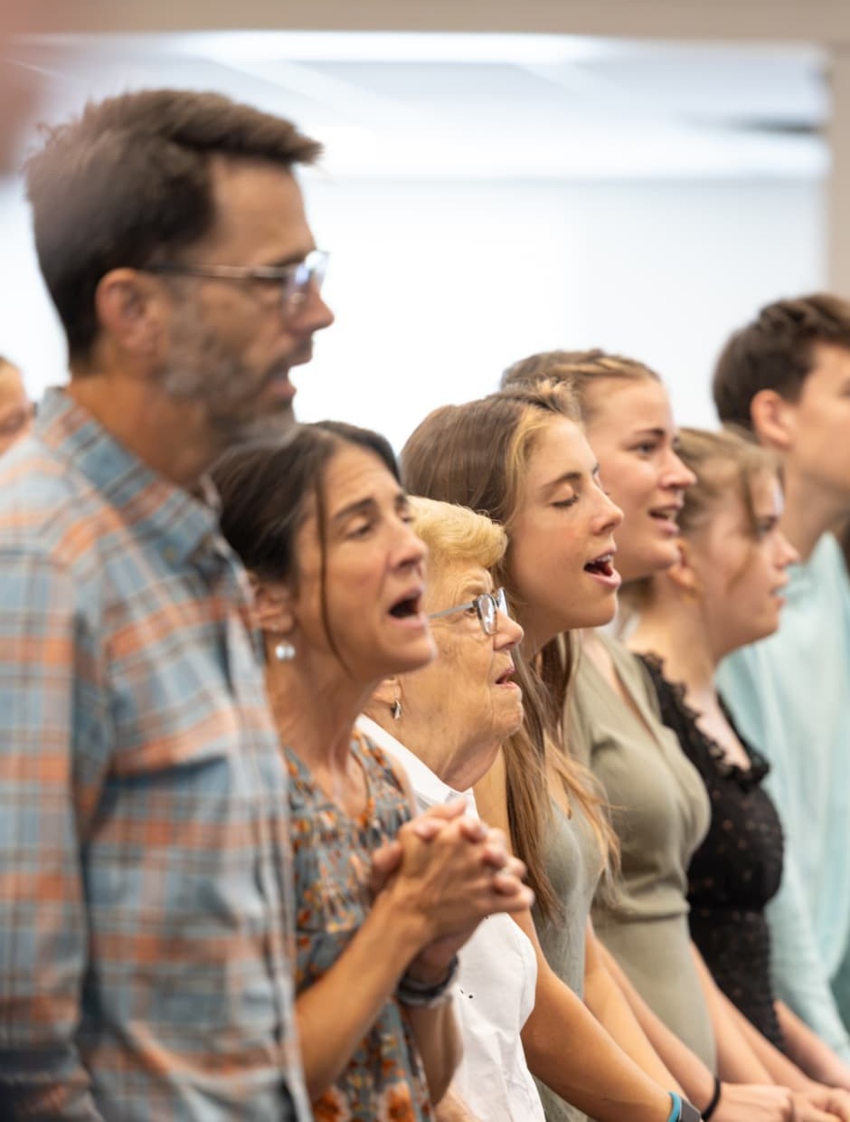 Congregation standing and worshiping together during a gathering at CrossLife